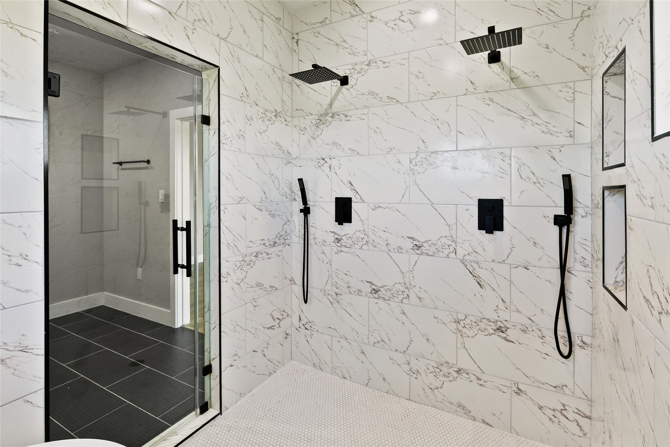 619 Chuckwagon Trail Angleton, TX 77515 - Photo 23 of 37 A stunning wet room serves as the centerpiece of the primary bath, combining a freestanding soaking tub and dual-head shower within a beautifully tiled space.