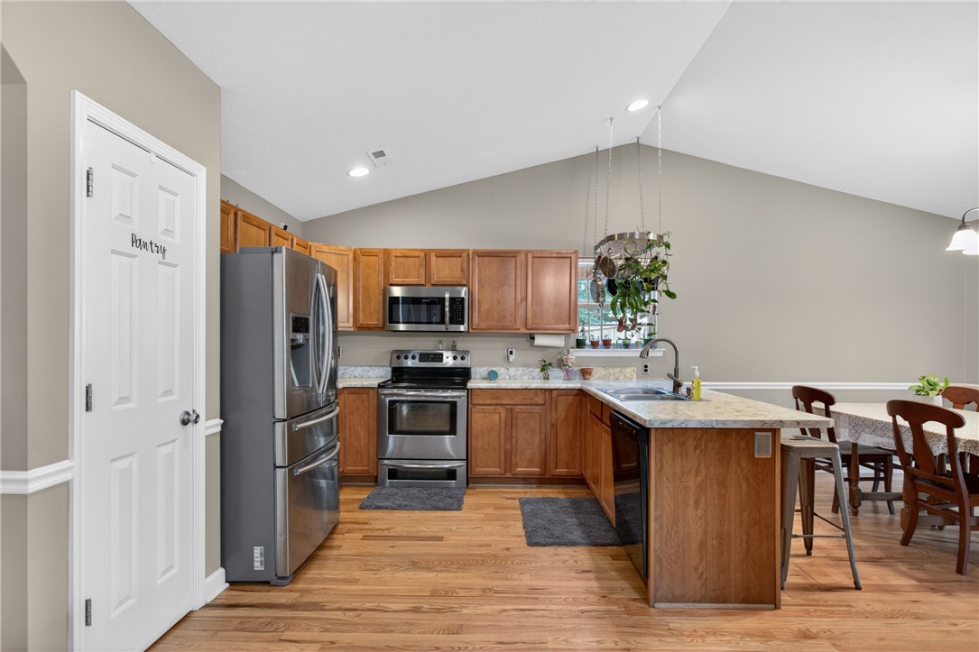 151 Towne Creek Trail Anderson, SC 29621 - Photo 6 of 49 A well-lit kitchen with soaring vaulted ceilings and rich wood flooring.