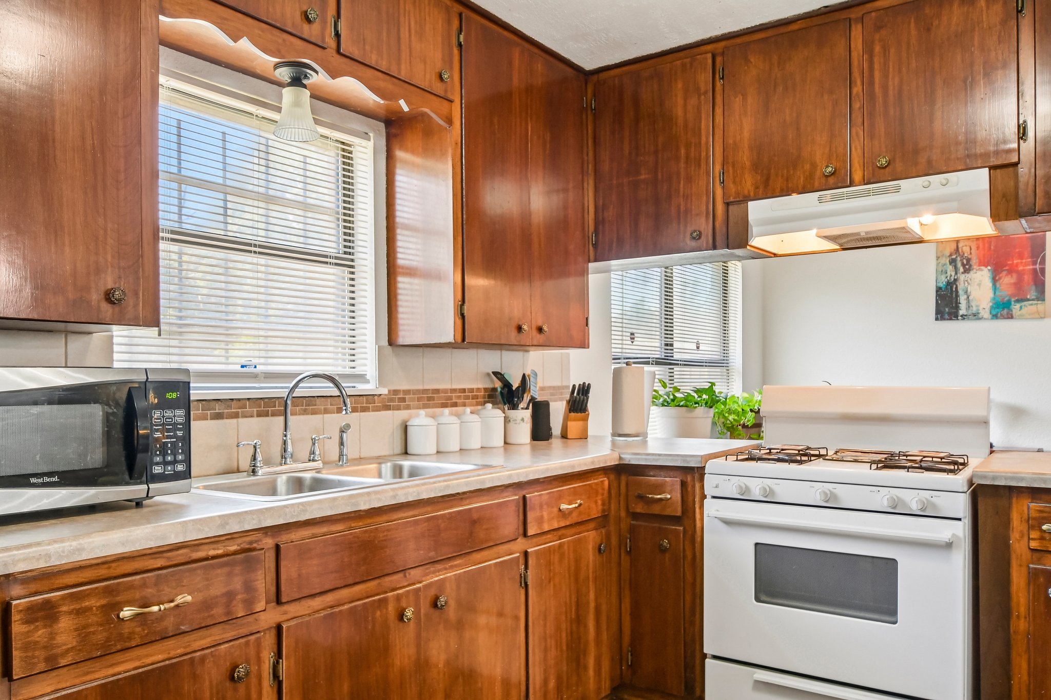 101 Brown Street Elgin, TX 78621 - Photo 9 of 32 a kitchen with stainless steel appliances a stove sink and cabinets