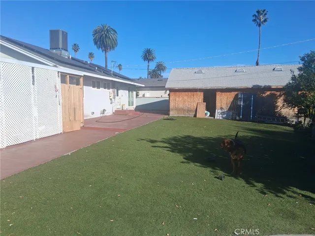 a living room with furniture a chandelier and a flat screen tv