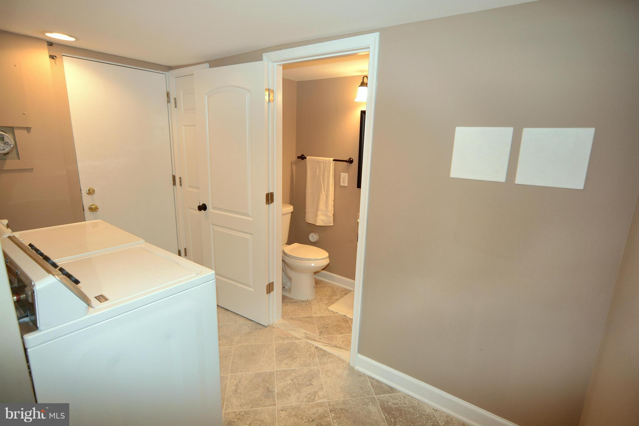 8507 Kavanagh Road Baltimore, MD 21222 - Photo 22 of 28 a bathroom with a sink a toilet and shower