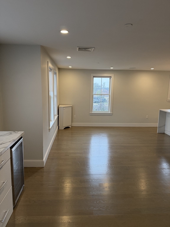 7 Saco Street, Unit 5 Boston, MA 02122 - Photo 2 of 13 an empty room with wooden floor and windows