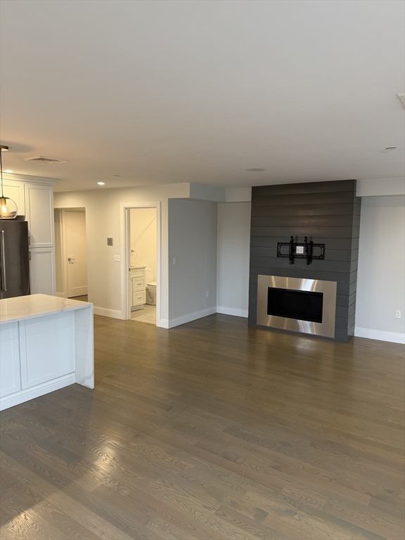 7 Saco Street, Unit 5 Boston, MA 02122 - Photo 3 of 13 a kitchen with granite countertop white cabinets and stainless steel appliances
