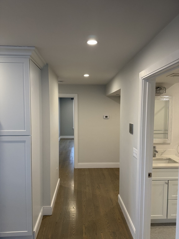 7 Saco Street, Unit 5 Boston, MA 02122 - Photo 5 of 13 a view of a hallway with wooden floor and closet area
