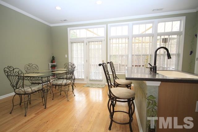 1439 Basinger Court Raleigh, NC 27612 - Photo 11 of 25 a dining room with furniture and wooden floor