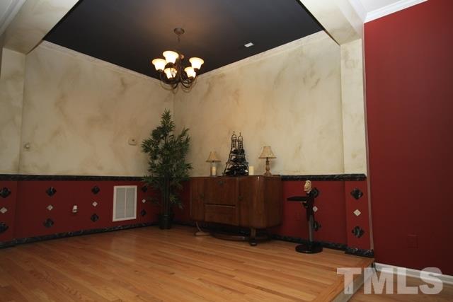 1439 Basinger Court Raleigh, NC 27612 - Photo 13 of 25 a view of a chandelier with a dresser