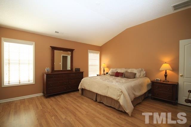 1439 Basinger Court Raleigh, NC 27612 - Photo 17 of 25 a bedroom with a bed and a window