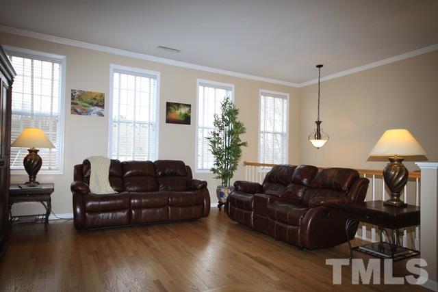 1439 Basinger Court Raleigh, NC 27612 - Photo 4 of 25 a living room with furniture and wooden floor