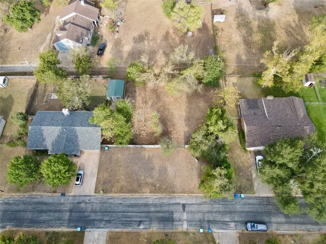 an aerial view of a house with garden space and sitting area