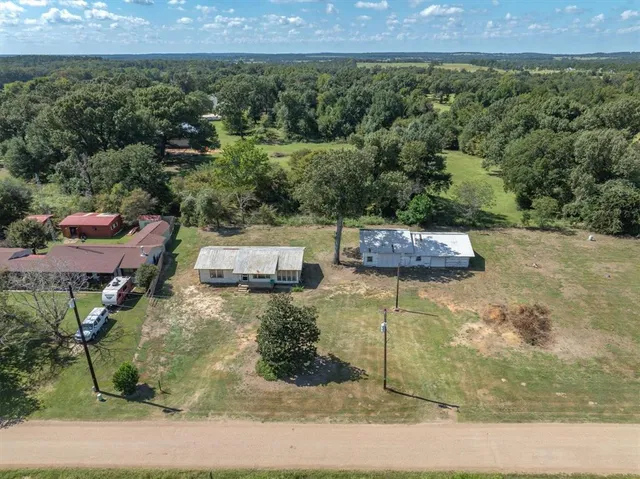 an aerial view of a house with a yard
