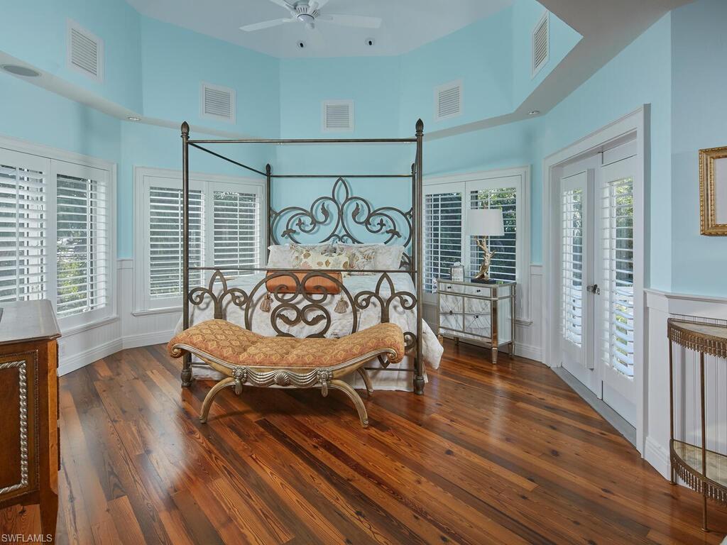 2750 Treasure Lane Naples, FL 34102 - Photo 13 of 28 a bedroom with furniture and wooden floor