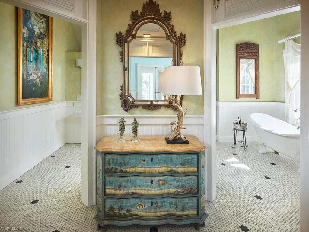2750 Treasure Lane Naples, FL 34102 - Photo 14 of 28 a bathroom with a sink and a mirror