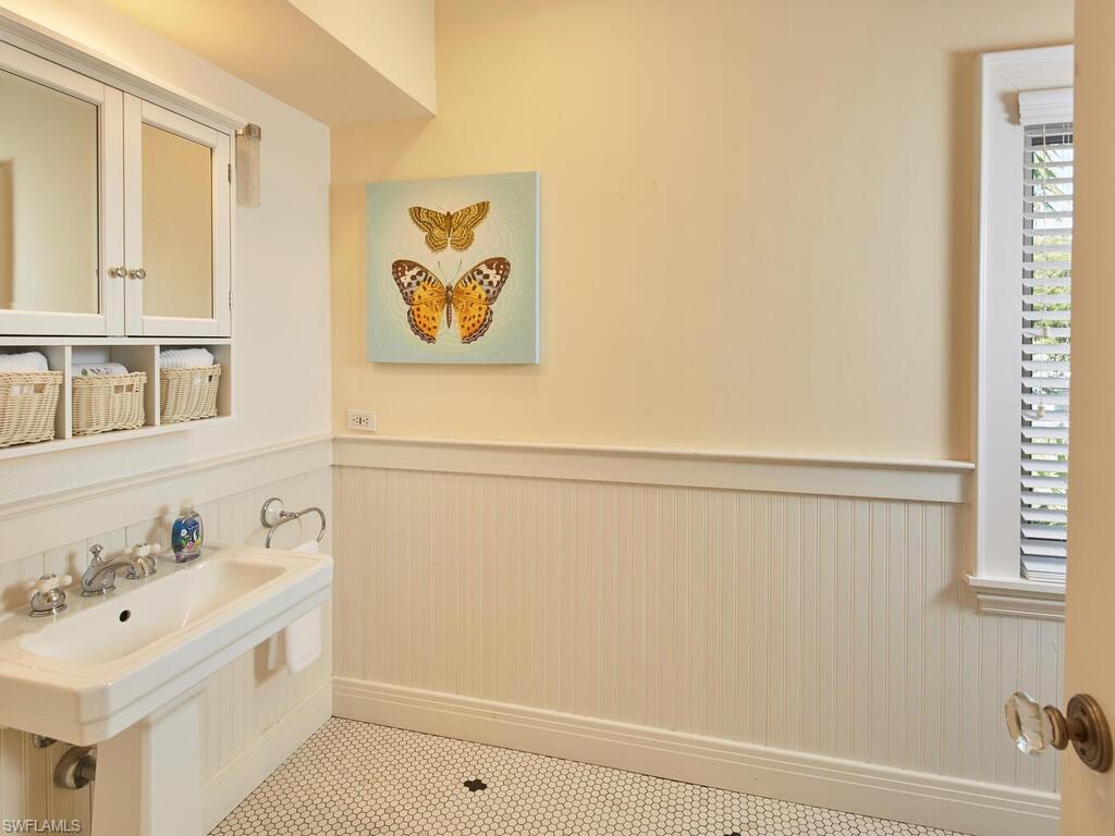 2750 Treasure Lane Naples, FL 34102 - Photo 19 of 28 a bathroom with a sink and a bathtub