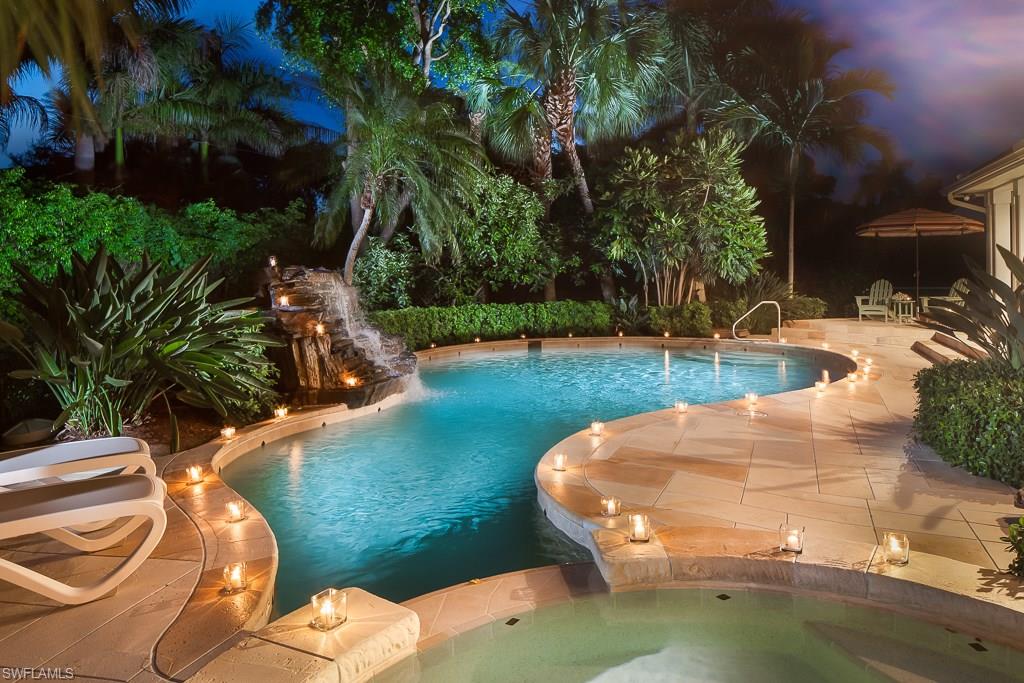 2750 Treasure Lane Naples, FL 34102 - Photo 2 of 28 a view of a swimming pool with an outdoor space