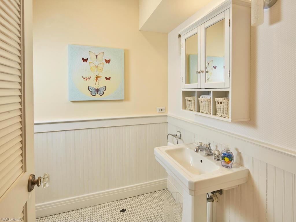 2750 Treasure Lane Naples, FL 34102 - Photo 21 of 28 a bathroom with a sink and a mirror