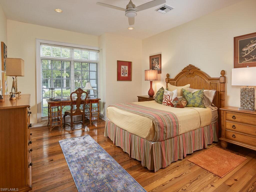 2750 Treasure Lane Naples, FL 34102 - Photo 22 of 28 a bedroom with a bed and wooden floor