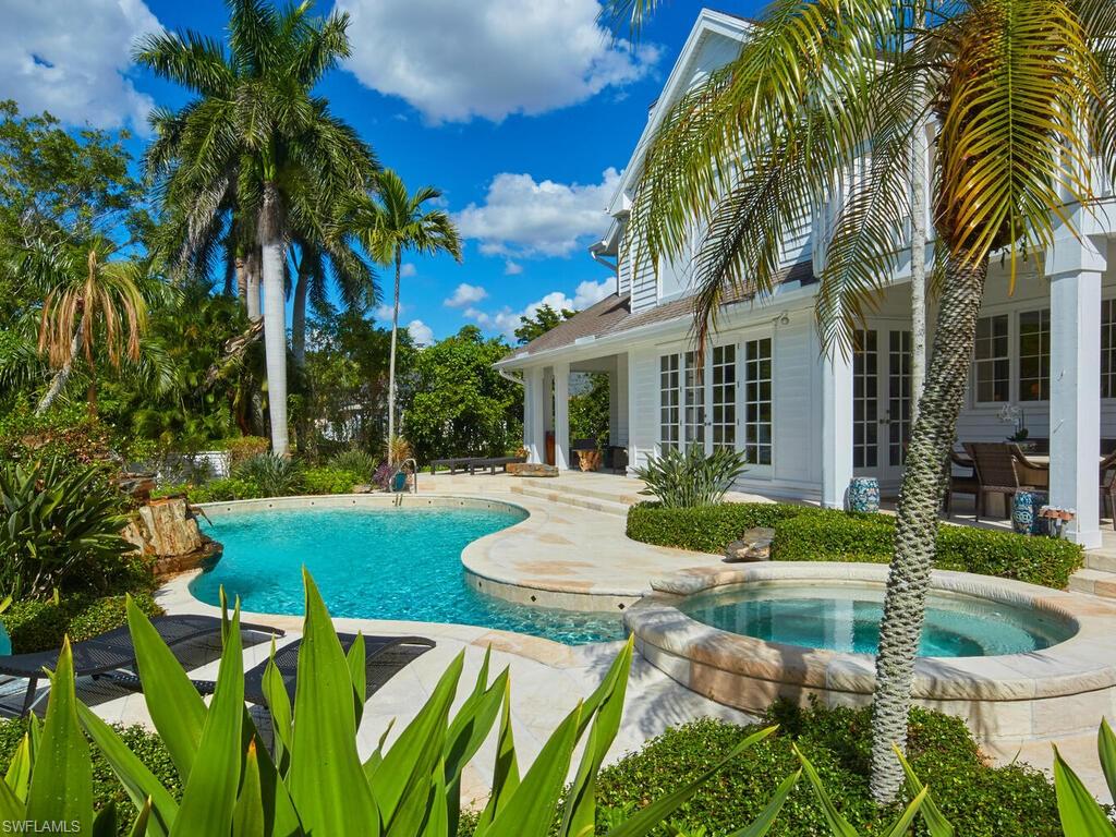 2750 Treasure Lane Naples, FL 34102 - Photo 27 of 28 a view of an house with backyard and swimming pool