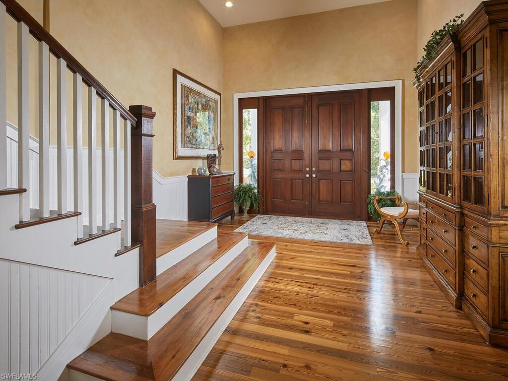 2750 Treasure Lane Naples, FL 34102 - Photo 4 of 28 a view of front door with wooden floor and stairs