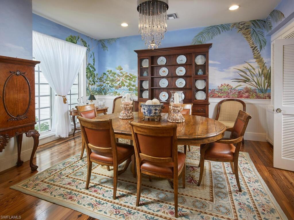 2750 Treasure Lane Naples, FL 34102 - Photo 6 of 28 a dining room with furniture a rug and wooden floor