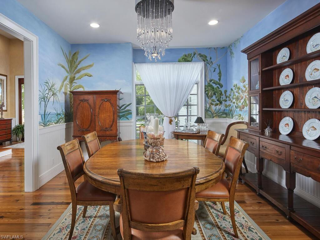 2750 Treasure Lane Naples, FL 34102 - Photo 7 of 28 a view of a dining room with furniture window and wooden floor