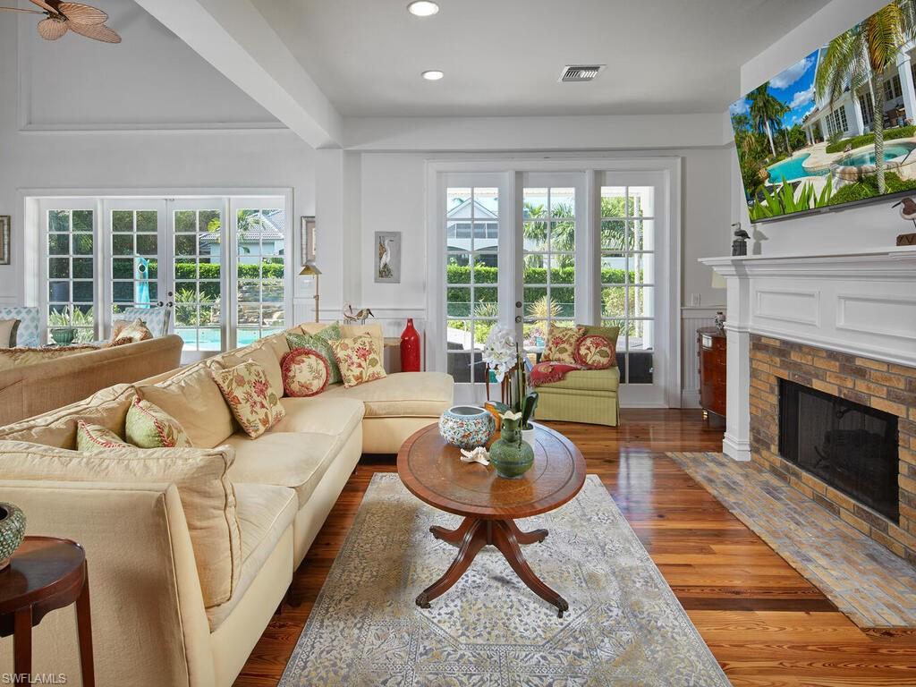 2750 Treasure Lane Naples, FL 34102 - Photo 8 of 28 a living room with furniture and a fireplace