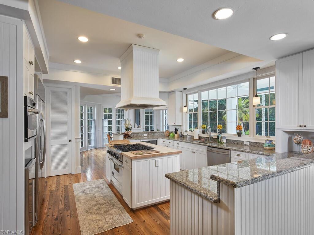 2750 Treasure Lane Naples, FL 34102 - Photo 9 of 28 a kitchen with sink stove and refrigerator
