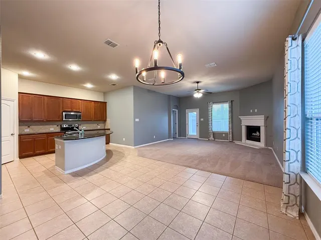 a view of a kitchen with stainless steel appliances granite countertop a sink and cabinets