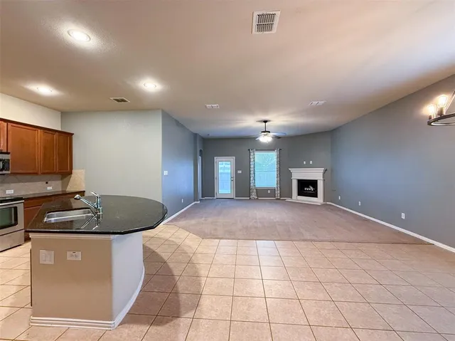a kitchen with granite countertop a sink stainless steel appliances and cabinets