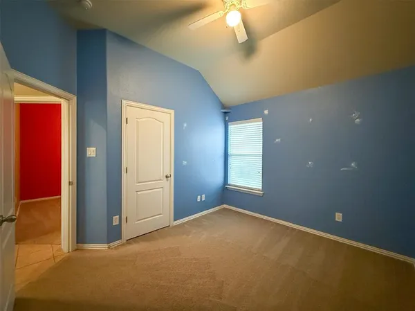 an empty room with windows and closet
