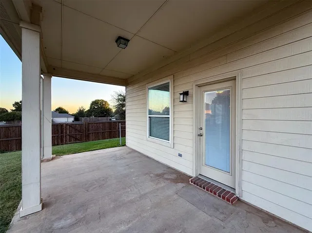 a view of a backyard with a wooden fence