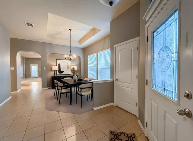 a dining room with furniture and window