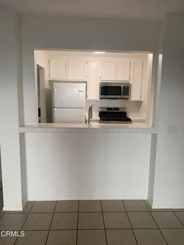 a kitchen with cabinets and steel stainless steel appliances
