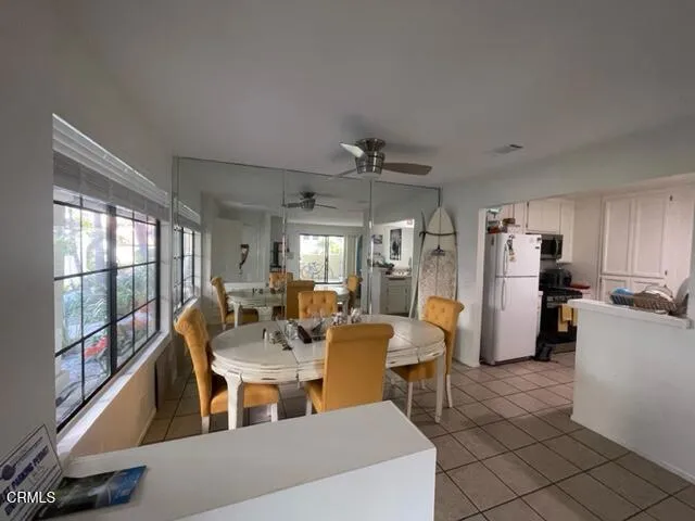 a dining room with furniture a chandelier and wooden floor