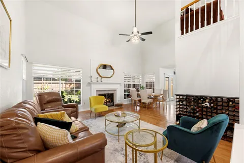 a living room with furniture fireplace and a window