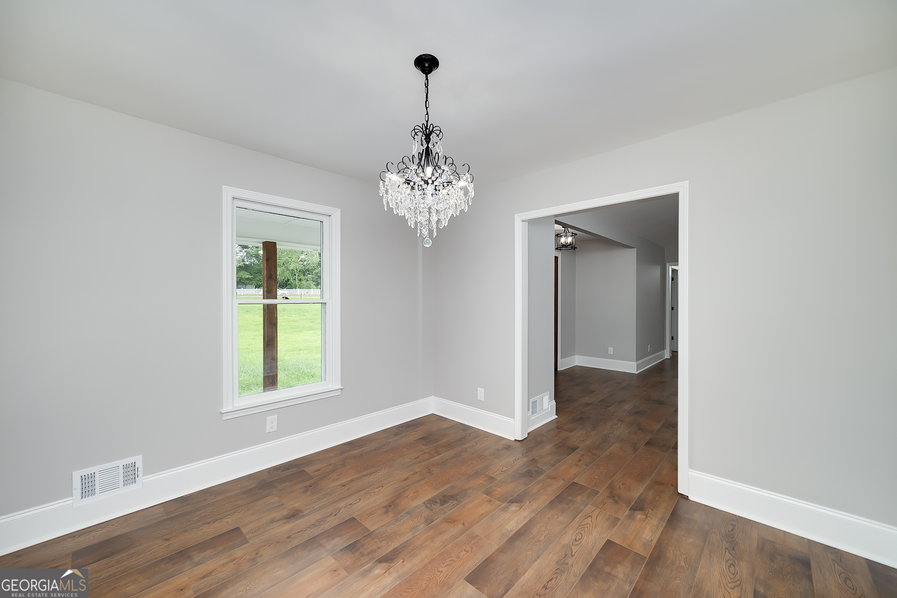 858 Pates Creek Road Stockbridge, GA 30281 - Photo 11 of 27 wooden floor in an empty room with a window