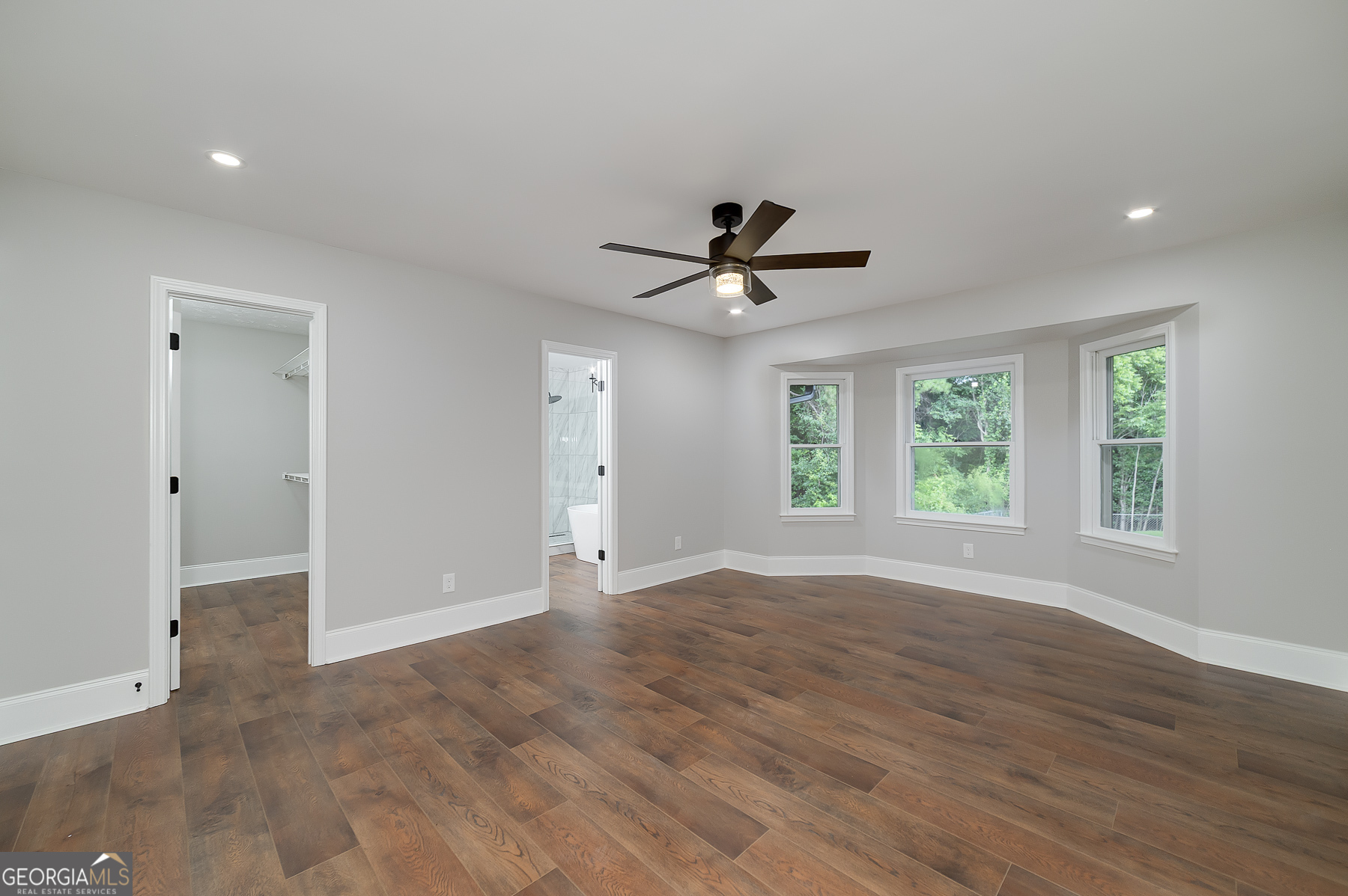 858 Pates Creek Road Stockbridge, GA 30281 - Photo 12 of 27 a view of empty room with wooden floor and fan