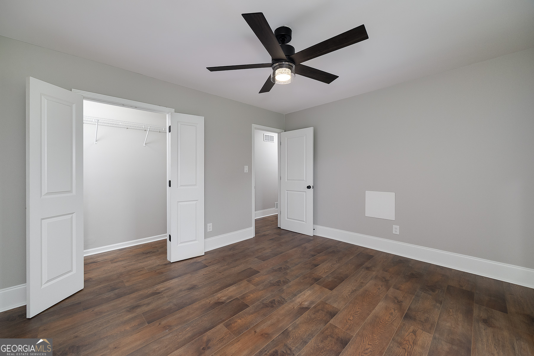 858 Pates Creek Road Stockbridge, GA 30281 - Photo 18 of 27 an empty room to hallway with wooden floor