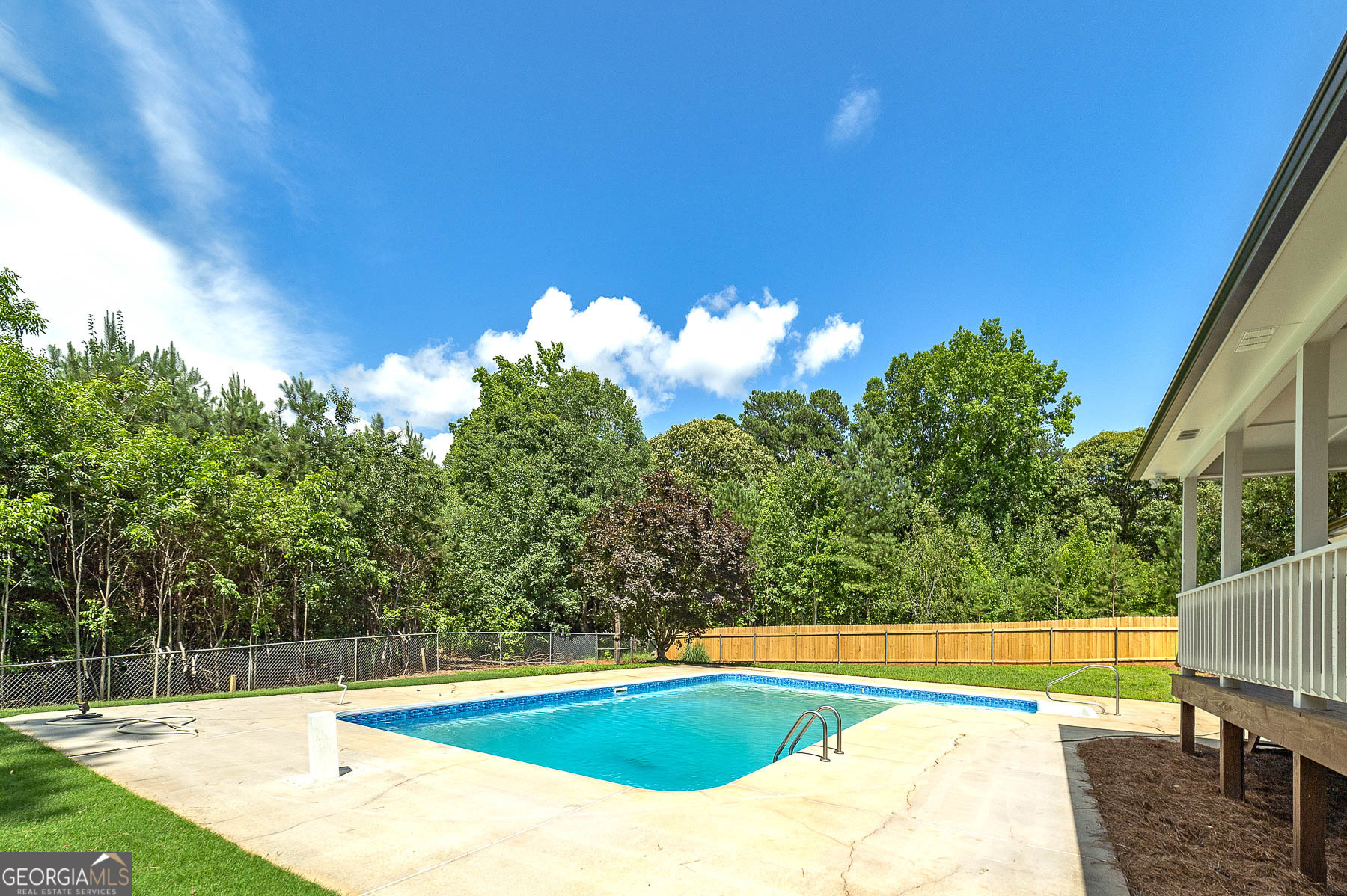 858 Pates Creek Road Stockbridge, GA 30281 - Photo 23 of 27 a view of a swimming pool with an outdoor space and seating area