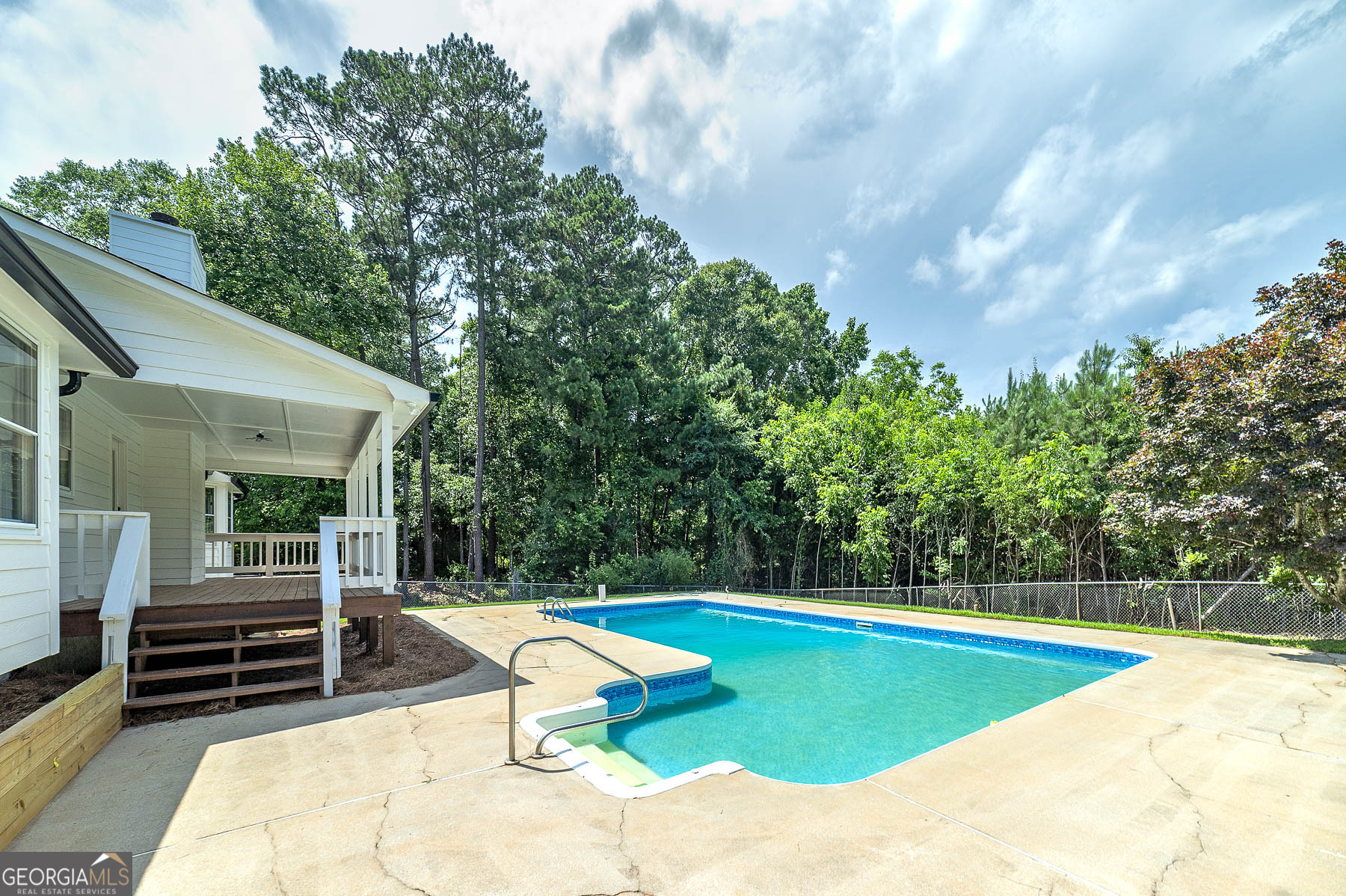 858 Pates Creek Road Stockbridge, GA 30281 - Photo 25 of 27 a view of a swimming pool with an outdoor seating and a yard
