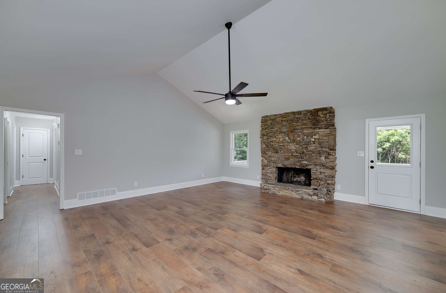 858 Pates Creek Road Stockbridge, GA 30281 - Photo 6 of 27 a view of a livingroom with a fireplace a ceiling fan and brick wall