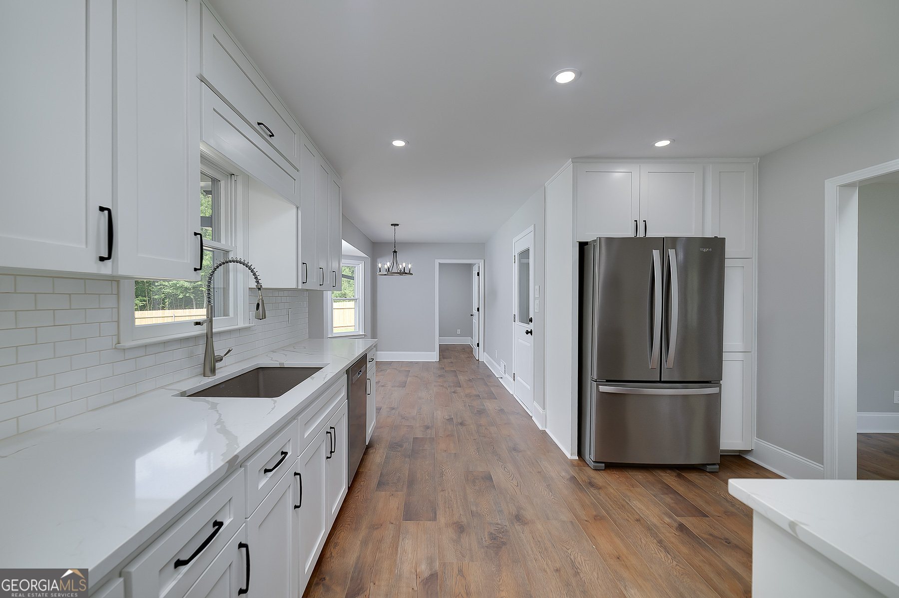 858 Pates Creek Road Stockbridge, GA 30281 - Photo 7 of 27 a kitchen with granite countertop a refrigerator and a sink