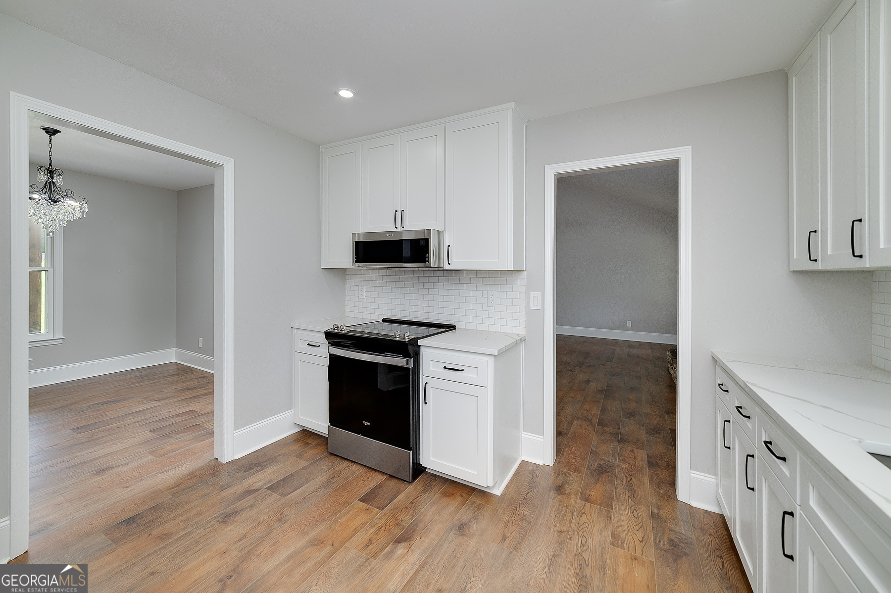 858 Pates Creek Road Stockbridge, GA 30281 - Photo 8 of 27 a kitchen with wooden floors and appliances