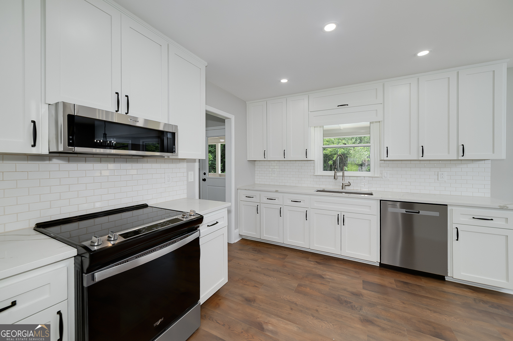 858 Pates Creek Road Stockbridge, GA 30281 - Photo 9 of 27 a kitchen with granite countertop cabinets stainless steel appliances and wooden floor