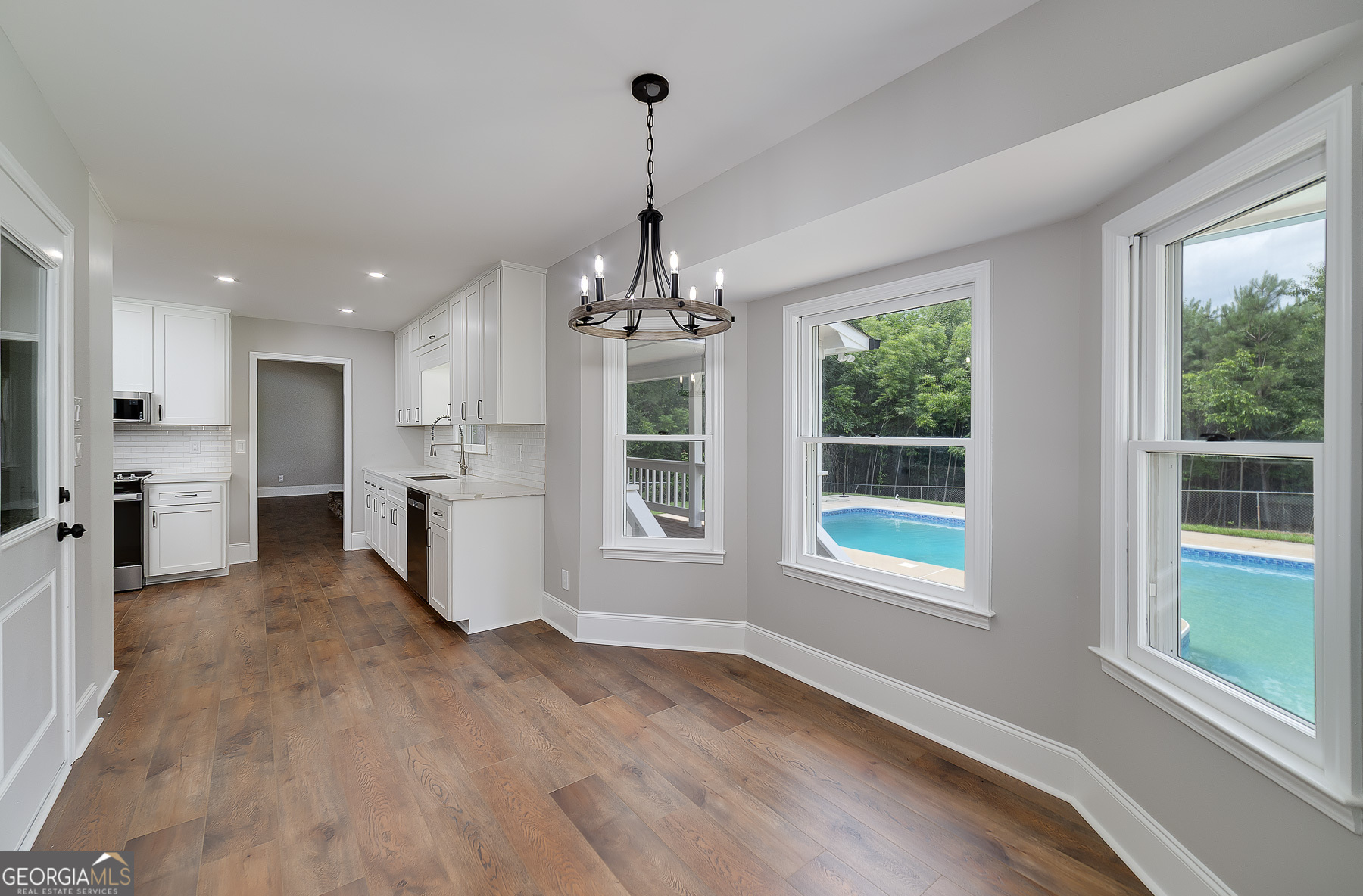 858 Pates Creek Road Stockbridge, GA 30281 - Photo 10 of 27 a view of a big room with windows and chandelier