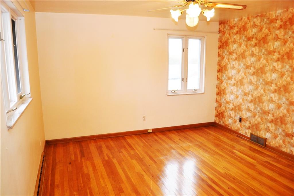 103 Lincoln Road Clairton, PA 15025 - Photo 23 of 39 an empty room with wooden floor and windows