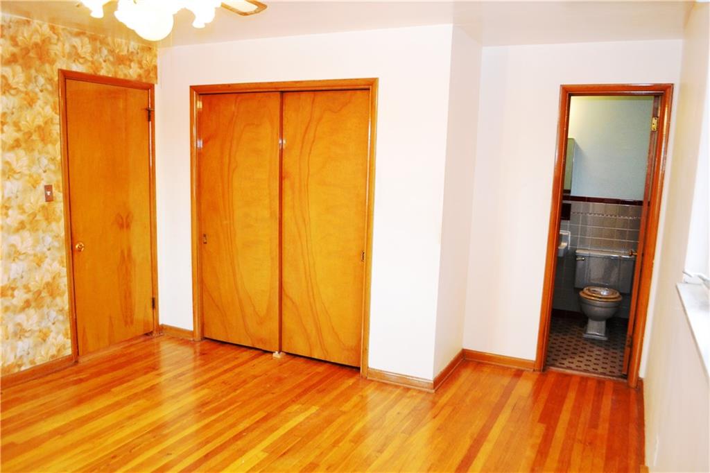 103 Lincoln Road Clairton, PA 15025 - Photo 5 of 39 a view of an empty room with wooden floor and a bathroom