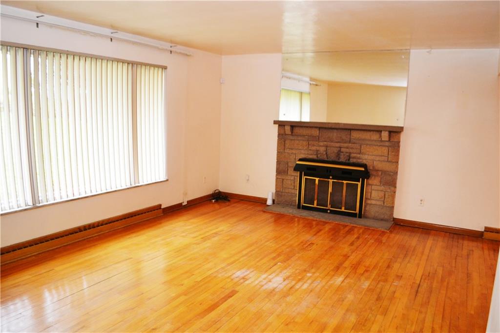 103 Lincoln Road Clairton, PA 15025 - Photo 8 of 39 a view of a livingroom with wooden floor and a fireplace