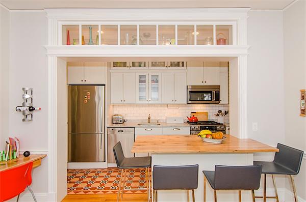 a kitchen with stainless steel appliances granite countertop a dining table and chairs