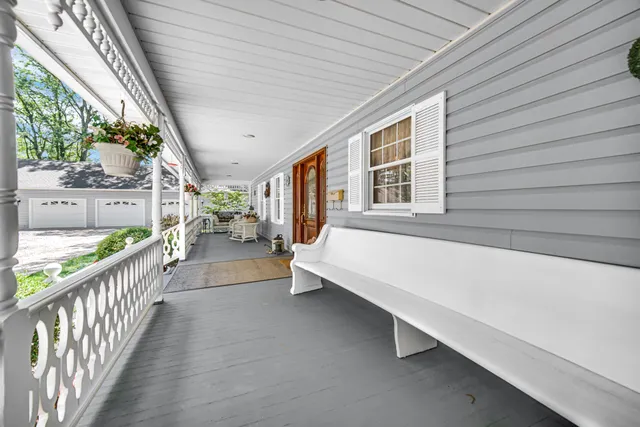 a view of a porch with wooden floor and iron fence