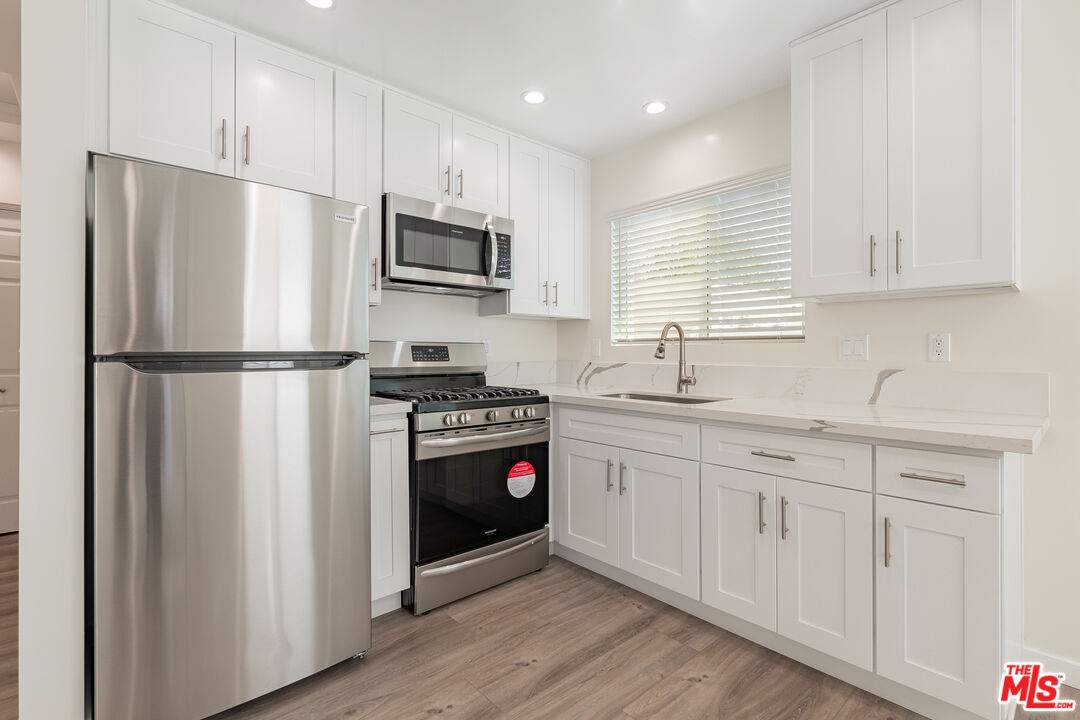 1049 Sonora Avenue, Unit A Glendale, CA 91201 - Photo 4 of 13 a kitchen with stainless steel appliances granite countertop a refrigerator sink and stove